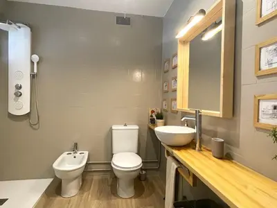 a bathroom with a white toilet and a sink at Your house in Porto in Vila Nova de Gaia