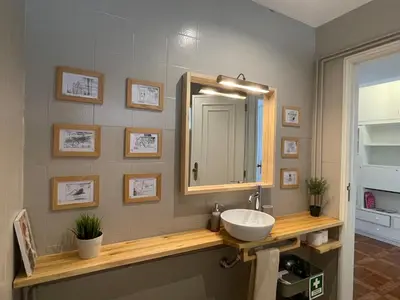 a bathroom with a sink and a mirror at Your house in Porto in Vila Nova de Gaia