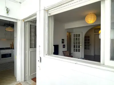 a view of a kitchen through a large window at Your house in Porto in Vila Nova de Gaia