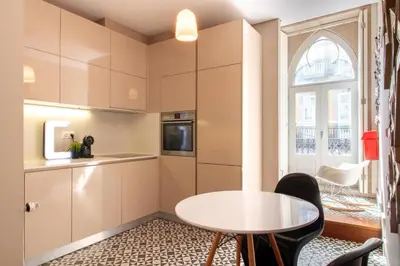 a kitchen with a table and chairs and a window at Cardosas Bright Studio by LovelyStay in Porto