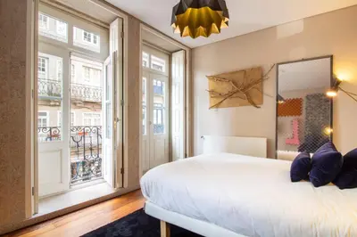 a bedroom with a bed and a large window at Cardosas Bright Studio by LovelyStay in Porto