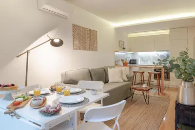 a living room with a couch and a table at Lovely & Centre Flat with Terrace by HostWise in Porto