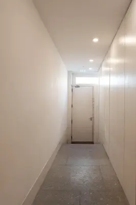 a corridor with a door in a white wall at Lovely & Centre Flat with Terrace by HostWise in Porto