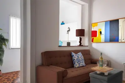 a living room with a brown couch and a table at Studio Faria Guimaraes in Porto