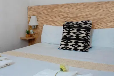 a bedroom with a bed with two pillows on it at Studio Faria Guimaraes in Porto