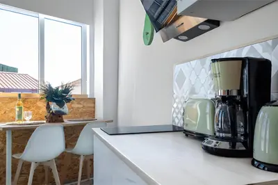 a kitchen with a coffee maker on a counter at Studios Faria Guimaraes in Porto