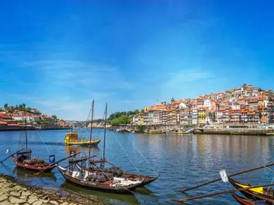 a group of boats in the water with a city at Apartment with Balcony for 4 Guests in Porto