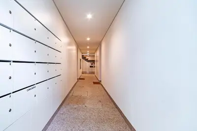 a hallway with white cabinets and a long corridor at NorteSoul OldTown - 2 Bedroom 2 Bathroom Apartment! in Porto