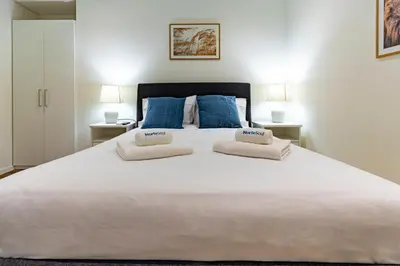 a large white bed with two pillows on it at NorteSoul OldTown - 2 Bedroom 2 Bathroom Apartment! in Porto