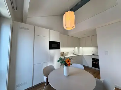 a kitchen with a table with a vase of flowers on it at AC, 2Bedrooms APT, City Center 900m to Metro in Porto