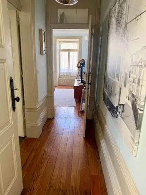 a hallway with wooden floors and a picture on the wall at Alegria Vintage Apartments - Porto in Porto