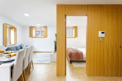 a kitchen and living room with a table and a dining room at Modern & Central Flat w/ Garage by HostWise in Porto