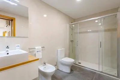 a bathroom with a toilet and a sink and a shower at Modern & Central Flat w/ Garage by HostWise in Porto