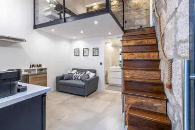 a staircase in a living room with a couch at Lapa 4 House in Porto