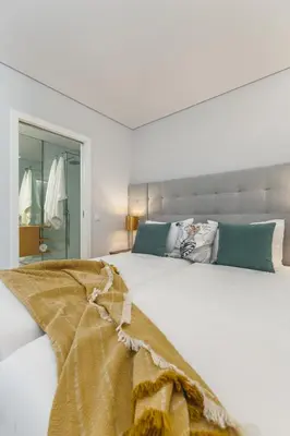 a white bedroom with a large white bed at Urban Oasis Six Suites Apts Porto in Porto