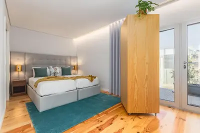 a bedroom with a bed and a large window at Urban Oasis Six Suites Apts Porto in Porto