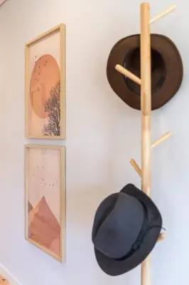 three framed pictures and a hat on a wall at Urban Oasis Six Suites Apts Porto in Porto