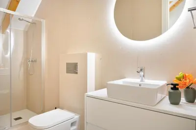 a bathroom with a sink and a toilet and a mirror at 89 T3 - Flores Gem in Porto