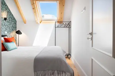 a bedroom with a bed and a window at 89 T3 - Flores Gem in Porto