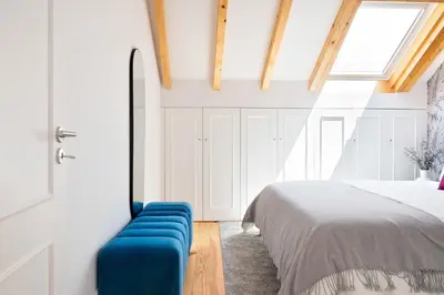 a bedroom with a bed and a blue couch at 89 T3 - Flores Gem in Porto
