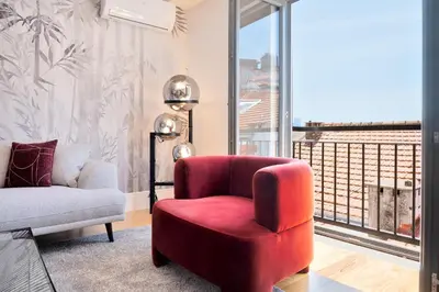 a living room with a red chair and a window at 89 T3 - Flores Gem in Porto