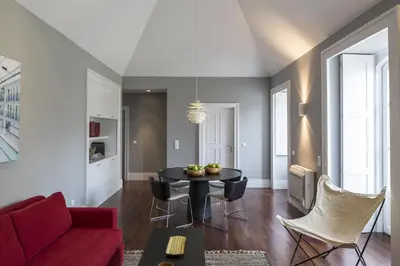 a living room with a red couch and a table at Oporto Serviced Apartments - Cedofeita in Porto