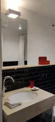 a bathroom counter with a sink and a mirror at Oporto Serviced Apartments - Cedofeita in Porto