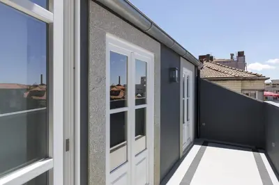 a balcony with doors and a view of the city at Oporto Serviced Apartments - Cedofeita in Porto