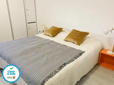 a bed with two pillows on it in a room at In Love Bolhão in Porto