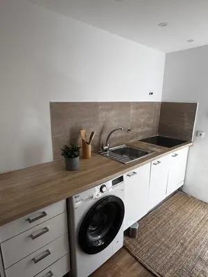 a kitchen with a washing machine and a sink at Simple House in the Heart of the Historic Center in Porto
