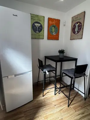 a kitchen with a table and chairs and a refrigerator at Simple House in the Heart of the Historic Center in Porto