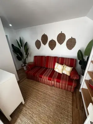 a red couch sitting in a living room at Simple House in the Heart of the Historic Center in Porto