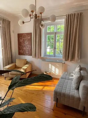 a living room with a couch and a window at Porto Surf Lodge in Porto