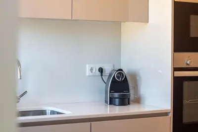a black appliance sitting on a counter in a kitchen at Peaceful 1BR Near Metro by LovelyStay in Porto