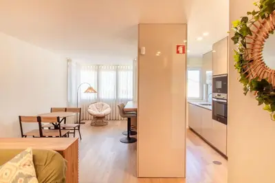 a kitchen and living room with a table and a dining room at Peaceful 1BR Near Metro by LovelyStay in Porto