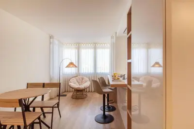 a living room with a table and a dining room at Peaceful 1BR Near Metro by LovelyStay in Porto