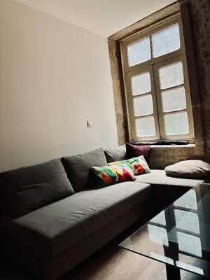 a couch in a living room with a window at Porto Old Town Escape in Porto