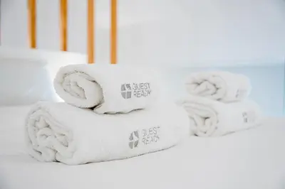 a stack of white towels on a shelf at GuestReady - Lovely nook with mezzanine in Porto