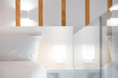 a bedroom with a bed with two lamps on it at GuestReady - Lovely nook with mezzanine in Porto