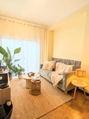a living room with a couch and two tables at 5E Apartment in the center of Porto in Porto