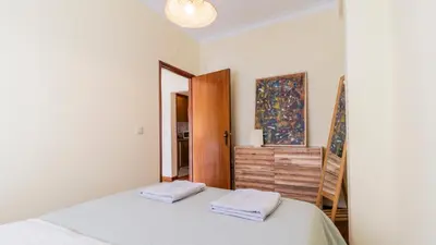 a bedroom with a large bed and a mirror at 5E Apartment in the center of Porto in Porto