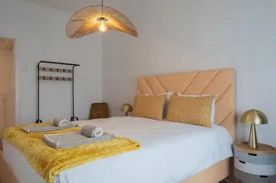 a bedroom with a bed with two towels on it at Purely Porto in Porto