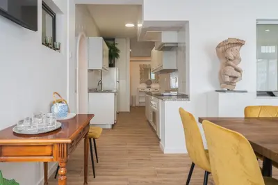 a kitchen and dining room with a wooden table and chairs at Purely Porto in Porto