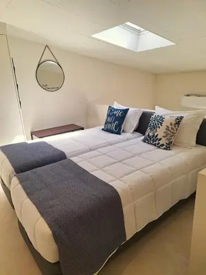 a bed with a blue pillow with a home sweet home at My 2ndHome Porto Villa in Porto