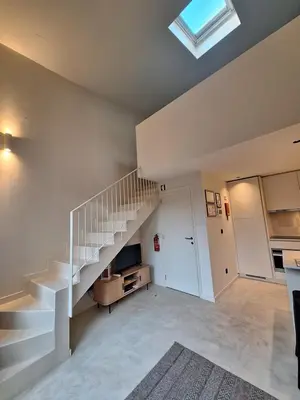 a large kitchen with white cabinets and a counter at My 2ndHome Porto Villa in Porto