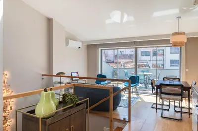 a living room with a table and a dining room at Oliveirinhas Boutique Flats in Porto