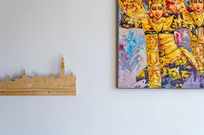 two paintings hanging on a white wall next to a painting at St Catarina Flats in Porto