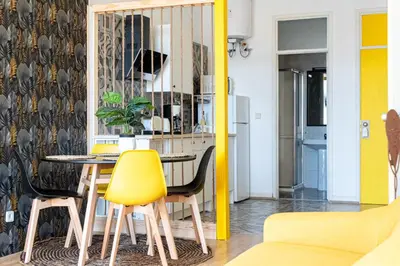 a dining room with a table and yellow chairs at St Catarina Flats in Porto