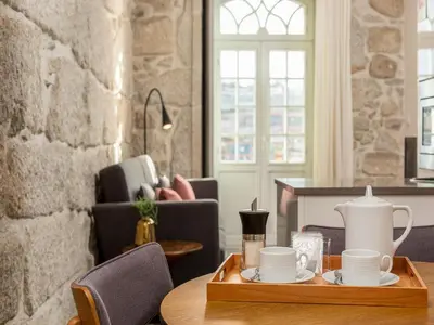 a dining room with a table with a tray of coffee cups at Porto Stay for 3 near Ribeira in Porto