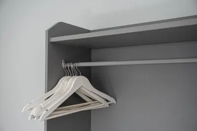 a closet with a white hanging rack in a room at GuestReady – Urban comfort in Vila Nova de Gaia in Vila Nova de Gaia